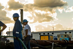 A group of workers examining a cable at a work site