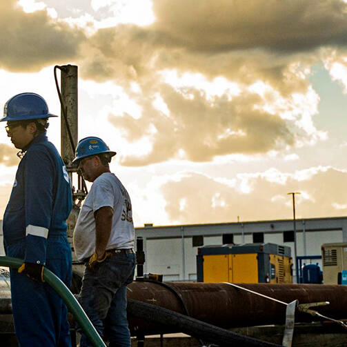 A group of workers examining a cable at a work site