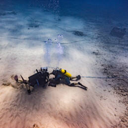 Two scuba swimmers installing an ULTRA sensor on the sea floor