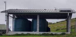 The DHHL Kahikinui site, a small open building containing reservoirs