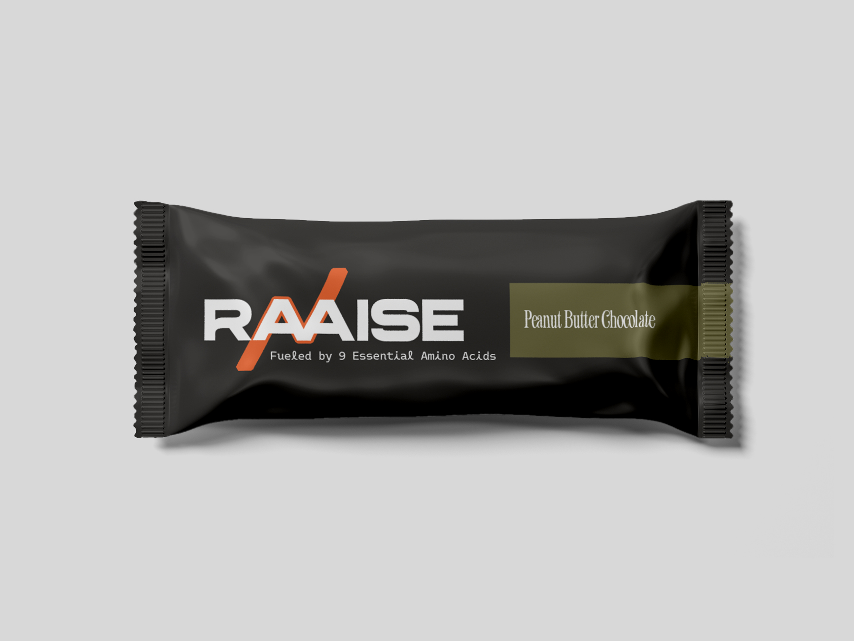 A black protein bar wrapper with RAAISE written in large white letters