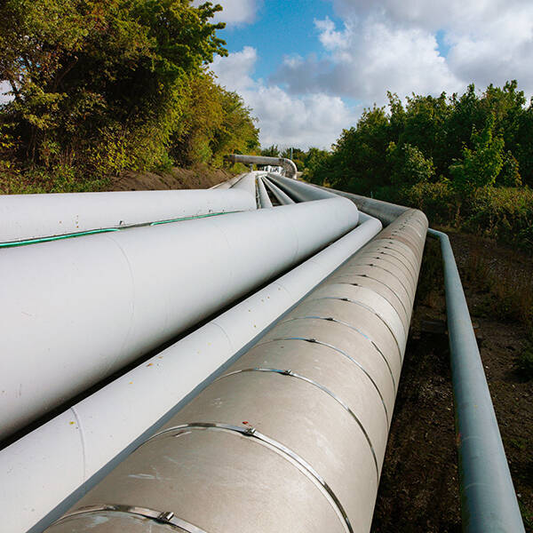 A photo of pipelines running across a natural landscape. DragX is an example of how Hawaii could help to reduce gas prices