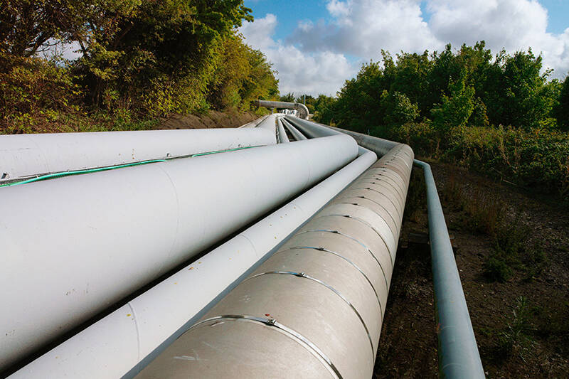 A photo of pipelines running across a natural landscape. DragX is an example of how Hawaii could help to reduce gas prices
