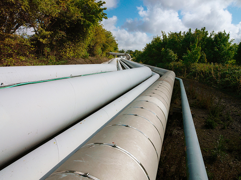 A photo of pipelines running across a natural landscape. DragX is an example of how Hawaii could help to reduce gas prices